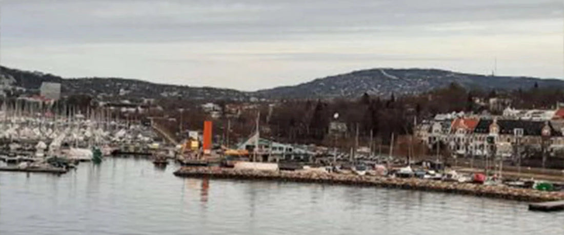 Boot fährt in die Hafeneinfahrt mit Blick auf den Hafen von Oslo