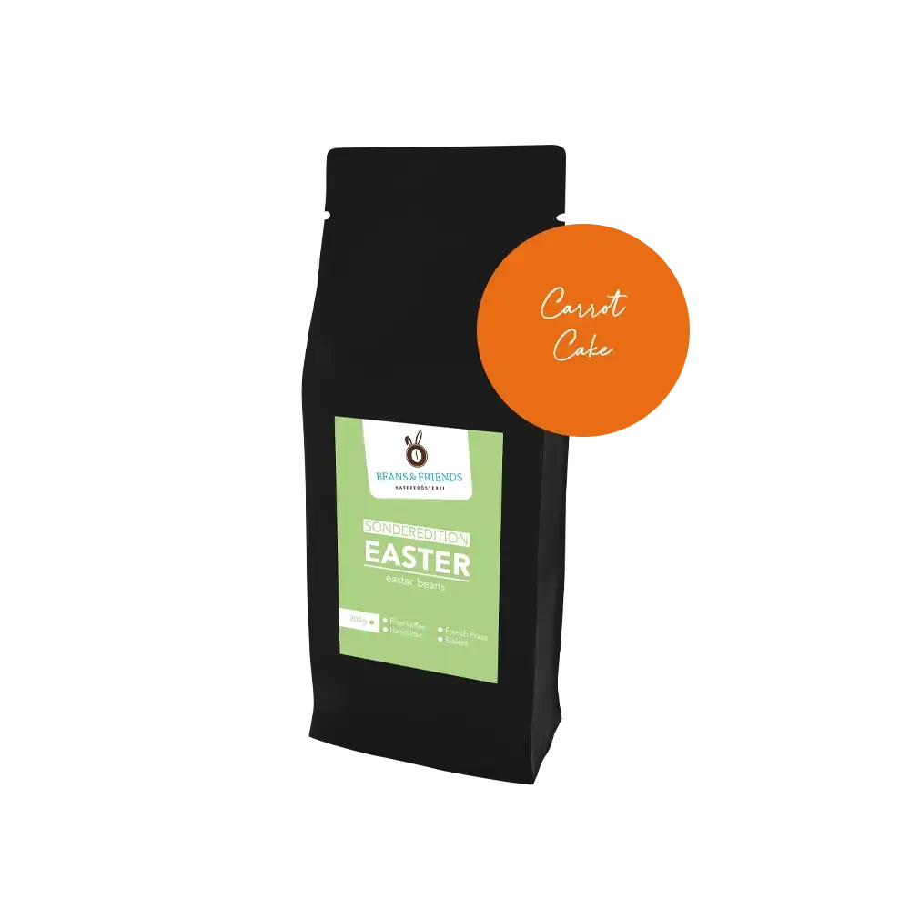 Easter Coffee Carrot Cake – Edle schwarze Verpackung mit frühlingshaftem grünen Etikett und runder Aufkleber, der die Geschmacksrichtung der Sorte anzeigt.